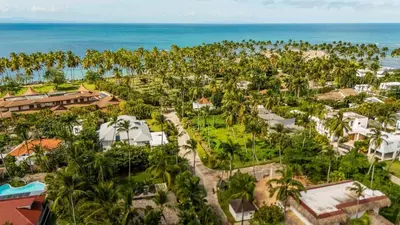 an aerial view of a resort with palm trees and the ocean at Lux villa playa bonita in Las Terrenas