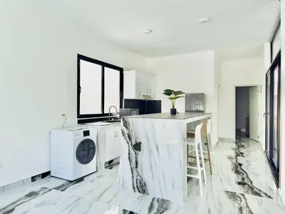a white kitchen with a washer and dryer in it at Villa Las Terrenas Cosón minutes Pool and AC in Las Terrenas