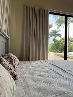 a bedroom with a bed with a view of the beach at Las Indgenas 6BR Pool Jacuzzi Gazebo in Imbert