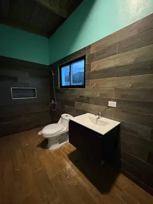 a bathroom with a toilet and a sink and a window at Las Indgenas 6BR Pool Jacuzzi Gazebo in Imbert