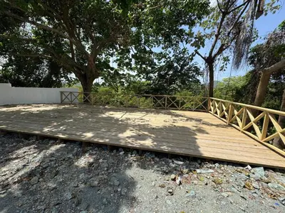 a wooden deck with a fence and a tree at Las Indgenas 6BR Pool Jacuzzi Gazebo in Imbert