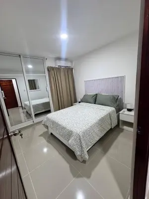a bedroom with a bed and a large mirror at Modern apartment in Santo Domingo in Juan López
