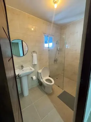 a bathroom with a toilet and a sink and a shower at Modern apartment in Santo Domingo in Juan López