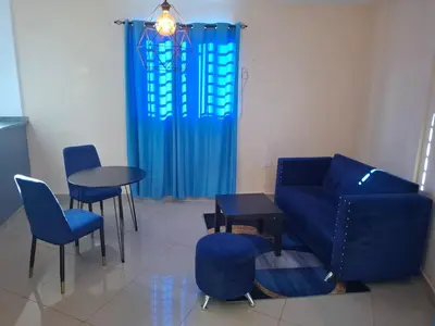 a living room with a couch and a table and chairs at Doña Minda Home in Naiboa