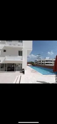 a large building with a swimming pool in front of it at BoCA DEL MAR 3 BOCA CHICA in Boca Chica