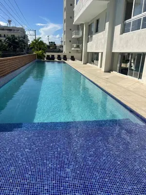 a swimming pool with blue tiles on the side of a building at BoCA DEL MAR 3 BOCA CHICA in Boca Chica