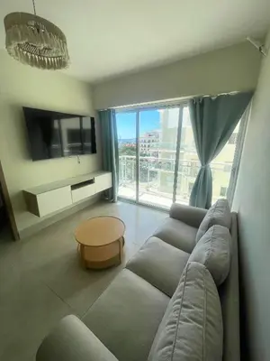 a living room with a couch and a large window at BoCA DEL MAR 3 BOCA CHICA in Boca Chica
