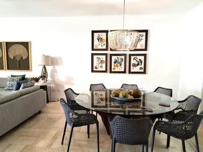 a dining room with a table and chairs at Gorgeous large condo, quiet beachfront complex in Las Terrenas