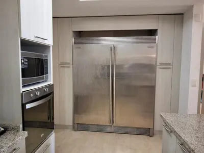 a kitchen with a large stainless steel refrigerator at Gorgeous large condo, quiet beachfront complex in Las Terrenas