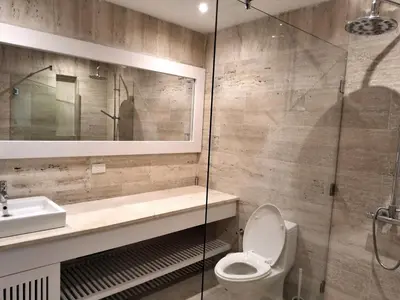 a bathroom with a toilet and a sink and a shower at Gorgeous large condo, quiet beachfront complex in Las Terrenas