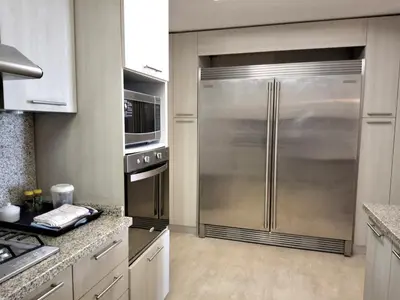 a kitchen with a large stainless steel refrigerator at Gorgeous large condo, quiet beachfront complex in Las Terrenas