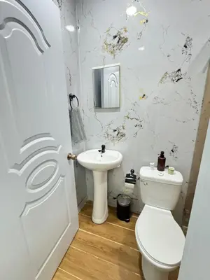a bathroom with a toilet and a sink at Hotel Evers in Azua