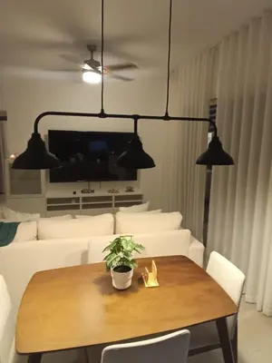 a living room with a table and a couch at Cozy tiny home by the beach in La Laguna