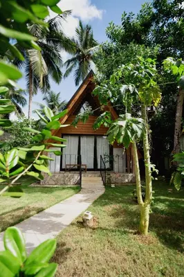 a small house in the middle of a garden at Casa Cayena - Hibiscus House in El Valle