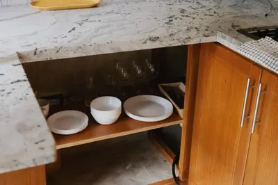 a cabinet with plates and bowls on top of it at Casa Cayena - Hibiscus House in El Valle