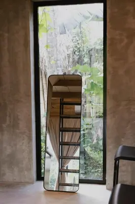 a staircase in a room with a large window at Casa Cayena - Hibiscus House in El Valle