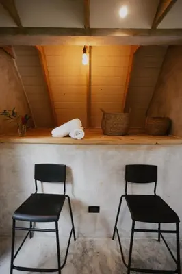 two chairs sitting in a room with a shelf at Casa Cayena - Hibiscus House in El Valle