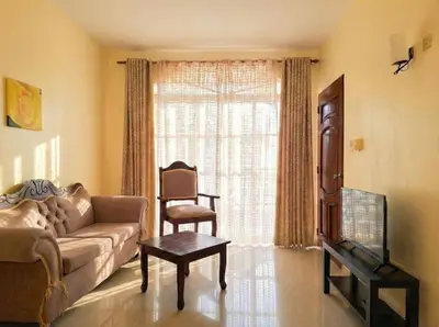 a living room with a couch and a chair and a window at Ocean Breeze 2BR Apt 50m to Beach Pool AC in San Felipe de Puerto Plata