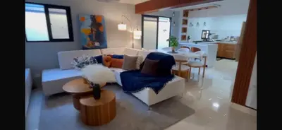 a living room with a couch and a table at D Gomez House in Santiago de los Caballeros