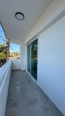 an empty room with a large window and a patio at Hotel Juan Dolio in Juan Dolio