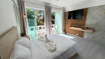 a bedroom with a large bed with towels on it at Hotel Juan Dolio in Juan Dolio