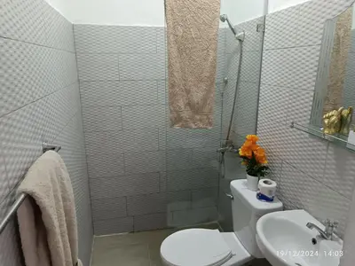 a bathroom with a white toilet and a sink at Casa de Huésped Romana in La Romana