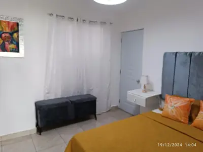 a white bedroom with a bed and a sink at Casa de Huésped Romana in La Romana