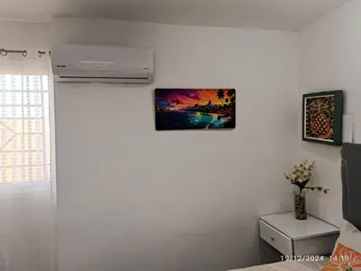 a white room with a picture on the wall at Casa de Huésped Romana in La Romana