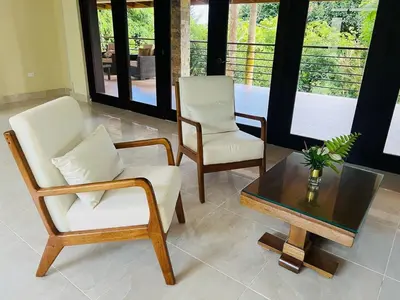 a living room with two chairs and a coffee table at Villa Reyes Vega - Private Pool & BBQ - La Colonia, SC in La Cabirma