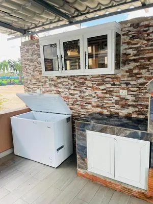 two white refrigerators sitting in front of a brick wall at Rancho Paraíso Escondido