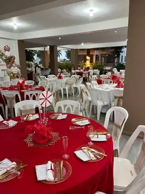 a dining room with white tables and red table cloth at Rancho Paraíso Escondido