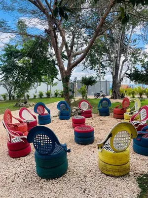 a group of colorful chairs in a park at Rancho Paraíso Escondido