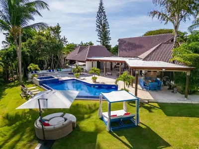 a backyard with a pool and a house at Villa Reme 19 in La Romana