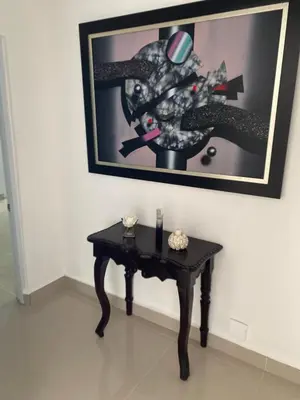 a black table in a room with a picture on the wall at Casa de campo Ana Victoria
