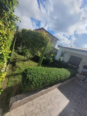 a house with a hedge in front of a house at Casa de campo Ana Victoria