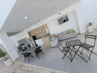 a living room with a couch and a table and chairs at Casa de campo Ana Victoria