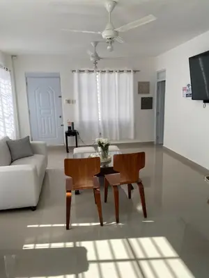 a living room with a couch and a table and chairs at Casa de campo Ana Victoria