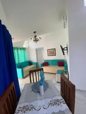 a living room with a table and a couch at Brisas del mar in San Felipe de Puerto Plata