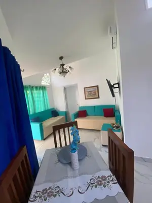 a living room with a table and a couch at Brisas del mar in San Felipe de Puerto Plata