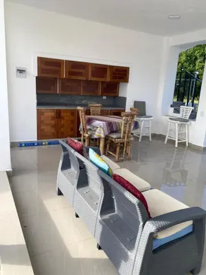 a living room with a couch and a table at Brisas del mar in San Felipe de Puerto Plata