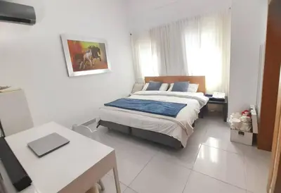 a bedroom with a large bed in a white room at Luxury 3-Bedroom Apartment with Pool in Naco, Santo Domingo in Santo Domingo