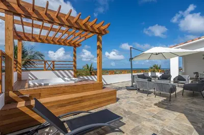 a deck with a hot tub and a pergola at Private Rooftop Penthouse Near Coson Beach Jacuzzi and BBQ in Las Terrenas