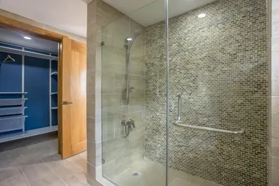 a bathroom with a shower with a glass door at Private Rooftop Penthouse Near Coson Beach Jacuzzi and BBQ in Las Terrenas