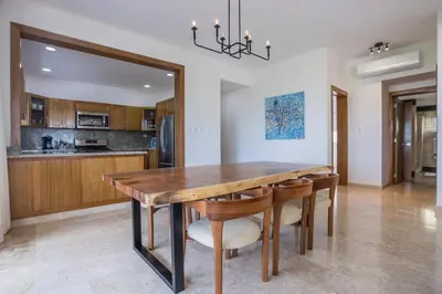 a dining room with a wooden table and chairs at Private Rooftop Penthouse Near Coson Beach Jacuzzi and BBQ in Las Terrenas