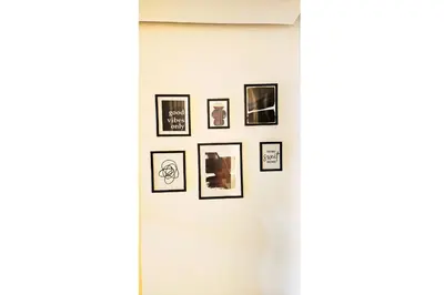 a group of pictures hanging on a wall at Cubana Stays in Santiago de los Caballeros