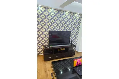 a living room with a tv and a dvd player at Cubana Stays in Santiago de los Caballeros