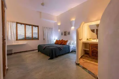a bedroom with a bed and a window at 5BR Serendipity Pool Ocean View Jungle in Las Terrenas