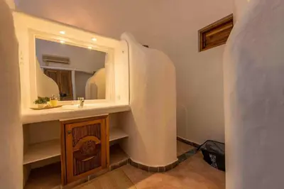 a bathroom with a sink and a mirror at 5BR Serendipity Pool Ocean View Jungle in Las Terrenas