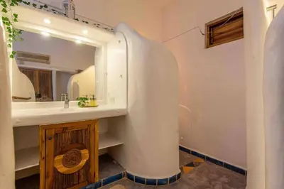 a bathroom with a sink and a mirror at 5BR Serendipity Pool Ocean View Jungle in Las Terrenas