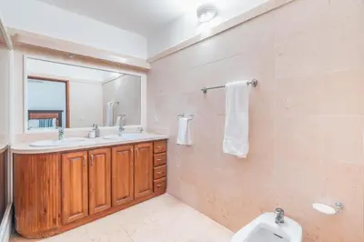 a bathroom with a toilet and a sink and a mirror at Comfortable villa with garden view and 3 bedrooms in Cajuiles